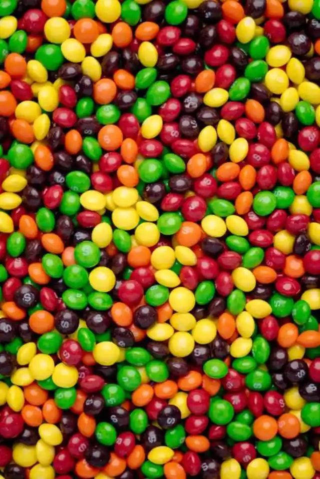There are a hundred Skittles in a bowl, and they only come in three colors: red, yellow, and green. How many red Skittles are there if 2/5 are yellow and 1/4 are green?