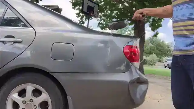 Repairing a Dent Using Hot Water and a Plunger